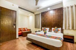 a bedroom with a large bed in a room at FabHotel Aashraye in New Delhi