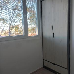 a room with a door and a window at Lovely 1- bedroom condo close to downtown in Skopje