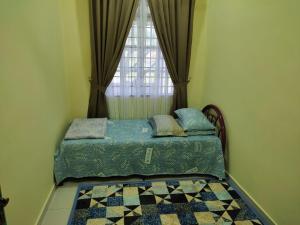 een kleine slaapkamer met een bed en een raam bij Homestay Salak 756 at Sungai Siput Kuala Kangsar for Islamic Guest Only in Sungei Siput