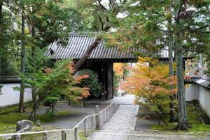 un sentiero in un giardino alberato e un edificio di Teppanyaki House a Kyoto