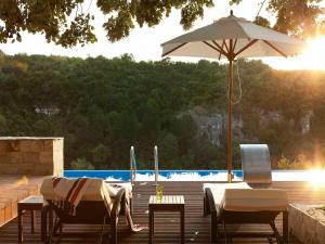 a person laying on a deck under an umbrella at Hotel Villa Kaylaka in Pleven