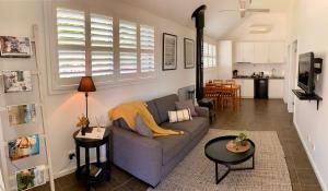 a living room with a couch and a table at Elevation652 at Mt Bellevue in King Valley in Myrrhee