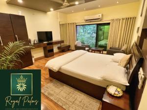 a bedroom with a bed and a living room at Royal Palms Luxury Service Apartment in Nagpur