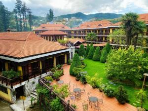 a resort with a courtyard with tables and chairs at BB Sapa Resort & Spa - Formerly Victoria Sapa Resort & Spa in Sapa