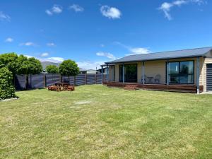 a house with a large yard in front of it at Apartment Style Holiday Home in Twizel