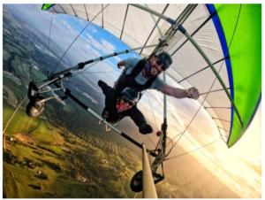 a couple of men are riding a parachute at Spectacular Gold Coast Skyline Views in Mount Tamborine