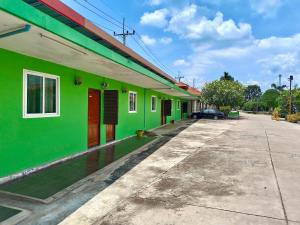 a row of colorful buildings on a street at โรงเกลือรีสอร์ท in Aranyaprathet