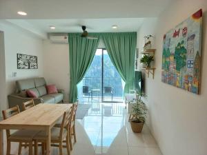 a living room with a wooden table and a couch at Sunway Onsen Theme Park View @Lost World of Tambun in Ipoh