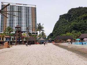 a sandy beach with a hotel and a resort at Sunway Onsen Theme Park View @Lost World of Tambun in Ipoh