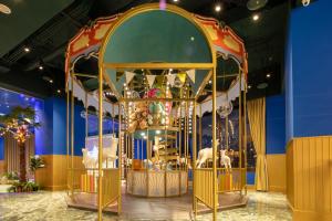 a christmas carousel in a room with blue walls at Roaders Plus Hotel - Taipei Station in Taipei