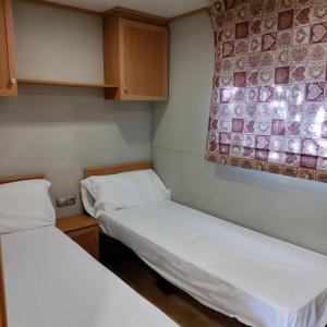 A bed or beds in a room at Camping Susen