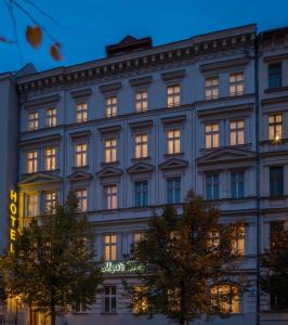 a facade of a building with lights on at Myer's Hotel Berlin in Berlin