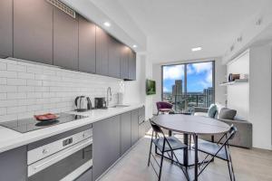 a kitchen with a table and some chairs in it at Modern 1 Bed Condo across from Bayside in Downtown in Miami