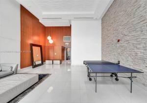 a ping pong table in a living room with a couch at Amazing Loft style 1 Bed with Water and City Views in Miami