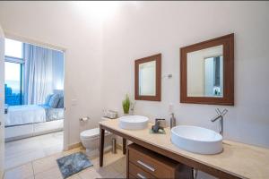a bathroom with two sinks and a toilet at Beautiful One Bedroom Condo 16ft ceilings at the W in Miami +27 photos