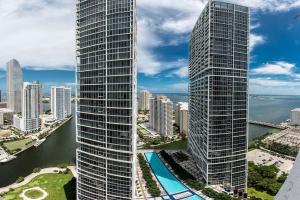 two tall buildings in a city next to a body of water at Beautiful One Bedroom Condo 16ft ceilings at the W in Miami