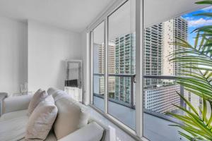 a living room with a white couch and a large window at Modern 1 Bed ICON Brickell with Amazing Views in Miami +34 photos