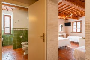 a bathroom with a toilet and a bedroom at Villa Maria - b&b di Charme in Vicopisano +84 photos