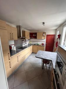 a kitchen with a table and a red refrigerator at Magnifique maison toulousaine in Toulouse