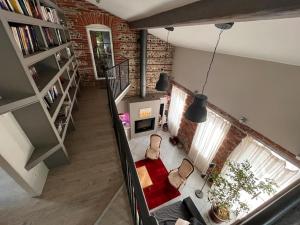 an overhead view of a living room with a brick wall at Magnifique maison toulousaine in Toulouse