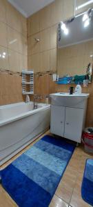 a bathroom with a tub and a sink and a bath tub at Apartament in Iaşi