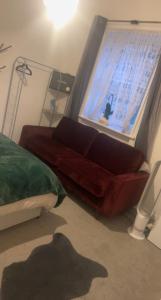 a living room with a couch and a window at Spacious Double Room in prime location London in London
