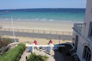 a view of the beach from the balcony of a building at Le Château de Sable in Plougasnou