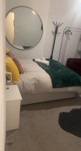 a bedroom with a bed with a mirror on the wall at Spacious Double Room in prime location London in London