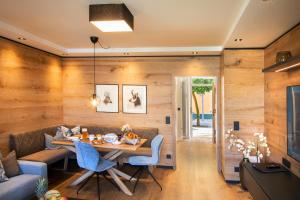 a dining room with a table and a couch at Weber Hofmark Apartments in Bad Birnbach