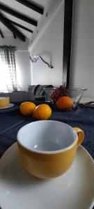 a yellow bowl on a table with oranges on it at Villa Lucín in Santander