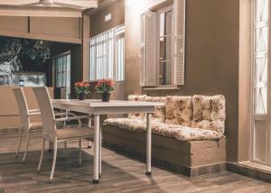 a table and chairs and a couch in a room at The Mills House in Kallithea