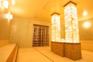 a large bathroom with a shower and a sink at Spa World HOTEL&RESORT in Osaka