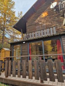 a log cabin with a bench on a deck at Boost Your Immo Vars Ô Chalet Dana 801 in Vars