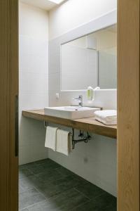 a bathroom with a sink and a mirror at Weinhof Reichmann in Sankt Peter am Ottersbach