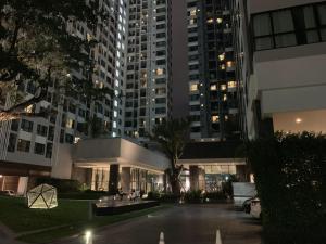 a view of a building at night with tall buildings at The Base Condo in Pattaya