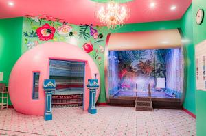 a room with a large pink tub in the middle at Spa World HOTEL&RESORT in Osaka