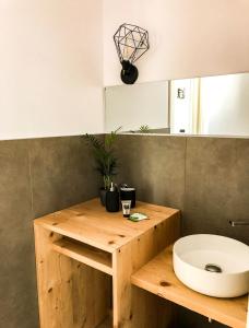 a bathroom with a wooden counter with a sink at Casa Rita in Brescia +9 photos