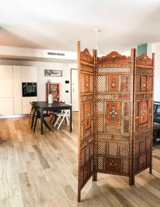 a large wooden door in a room with a table at Casa Rita in Brescia