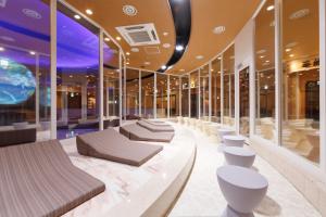 a hotel lobby with couches and tables and windows at Spa World HOTEL&RESORT in Osaka
