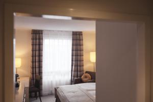 a hotel room with a bed and a window at Select Hotel Hamburg Nord in Hamburg