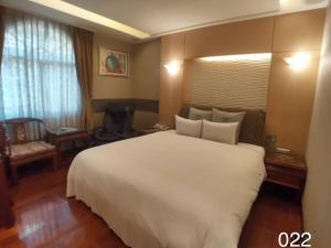A bed or beds in a room at Wunsin Motel
