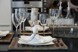 a table with wine glasses and a plate with a shoe on it at Kapitaensweg 24 in Karlshagen