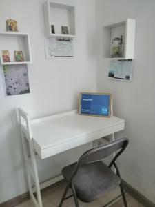 a white desk with a laptop on top of it at AmigoHD² in Hunedoara
