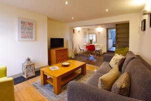 a living room with a couch and a coffee table at Old Fire Station Canterbury in Canterbury