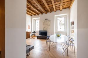 a living room with a table and chairs at Modern apartment in Campo de Fiori in Rome