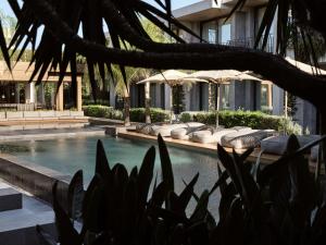 a swimming pool with umbrellas next to a building at Contessina Suites & Spa - Adults Only in Tsilivi