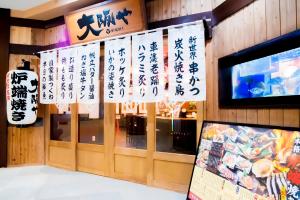 a restaurant with chinese signs on the wall at Spa World HOTEL&RESORT in Osaka