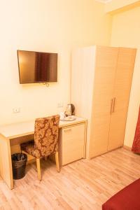 a room with a desk with a chair and a cabinet at Booking House Rome in Rome