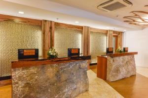 a hotel lobby with a large rock counter at Kabayan Hotel Pasay in Manila