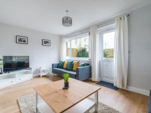 a living room with a couch and a table at Charming 3-Bed House in Newcastle upon Tyne in Newcastle upon Tyne